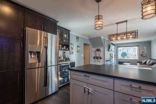 a kitchen with stainless steel appliances granite countertop a refrigerator a sink and a refrigerator