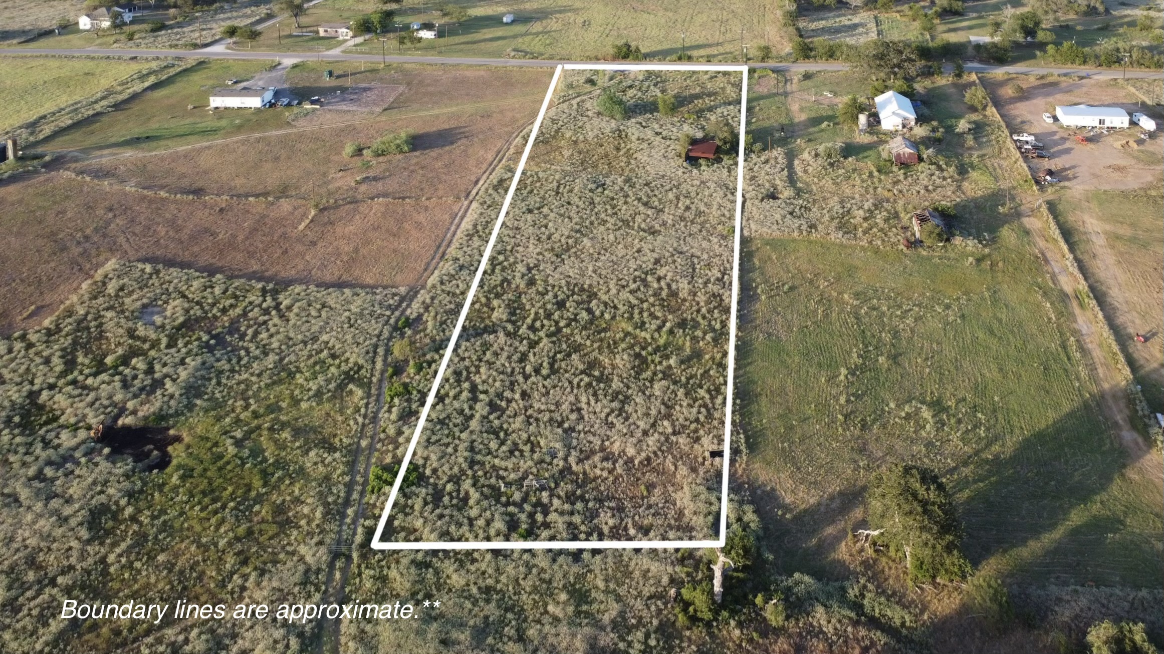 6447 Gander Slough Road Kingsbury, TX 78638 - Photo 12 of 16 An aerial perspective showcases the generous acreage of this rural lot outlined in white.