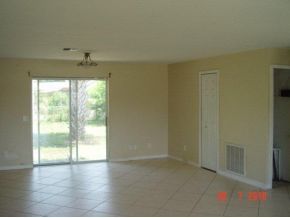 2430 Lisa Melbourne, FL 32935 - Photo 11 of 11 an empty room with wooden floor and windows