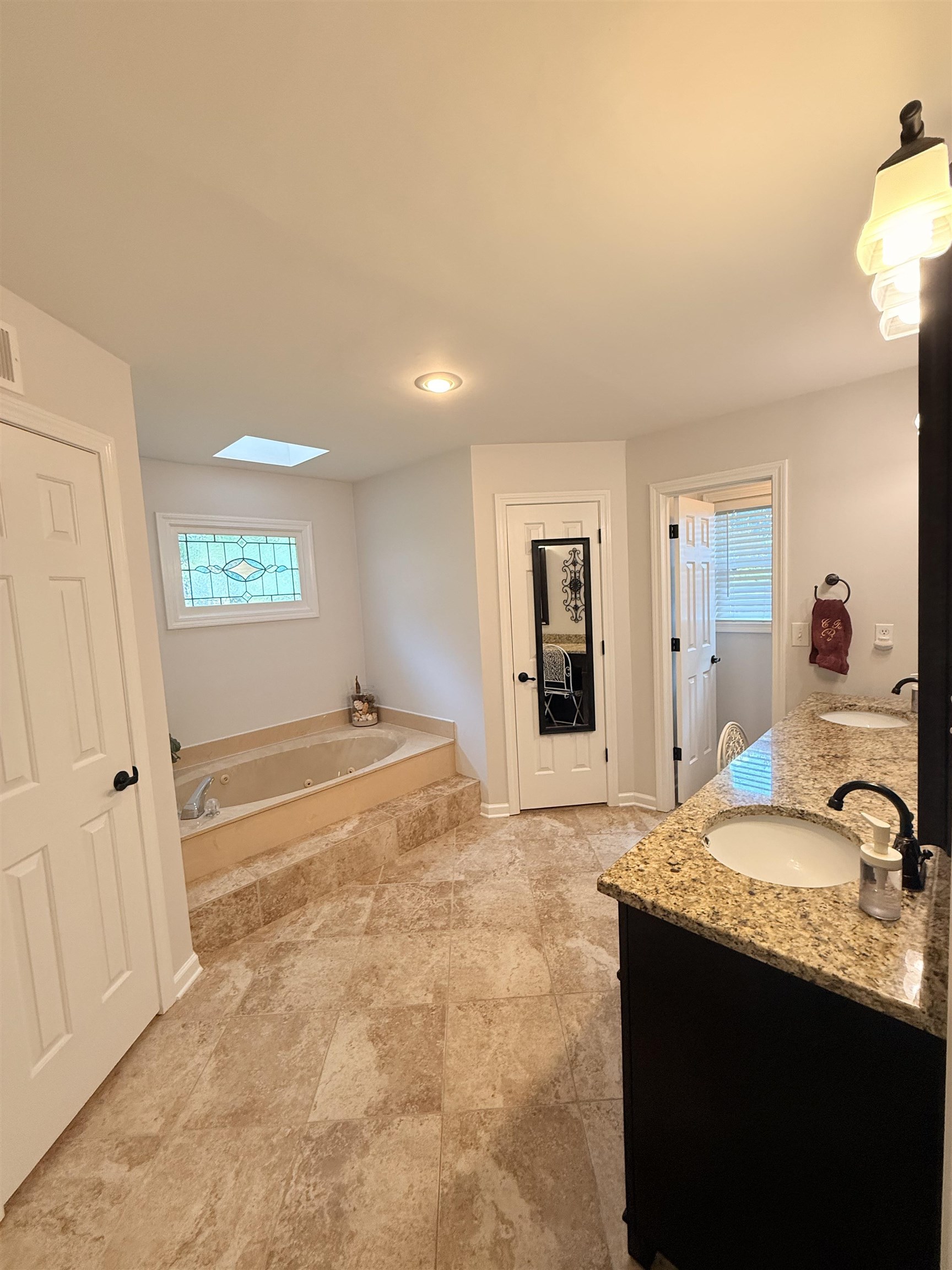 9140 Fox Ridge Road Germantown, TN 38139 - Photo 12 of 23 a spacious bathroom with a granite countertop sink and a mirror