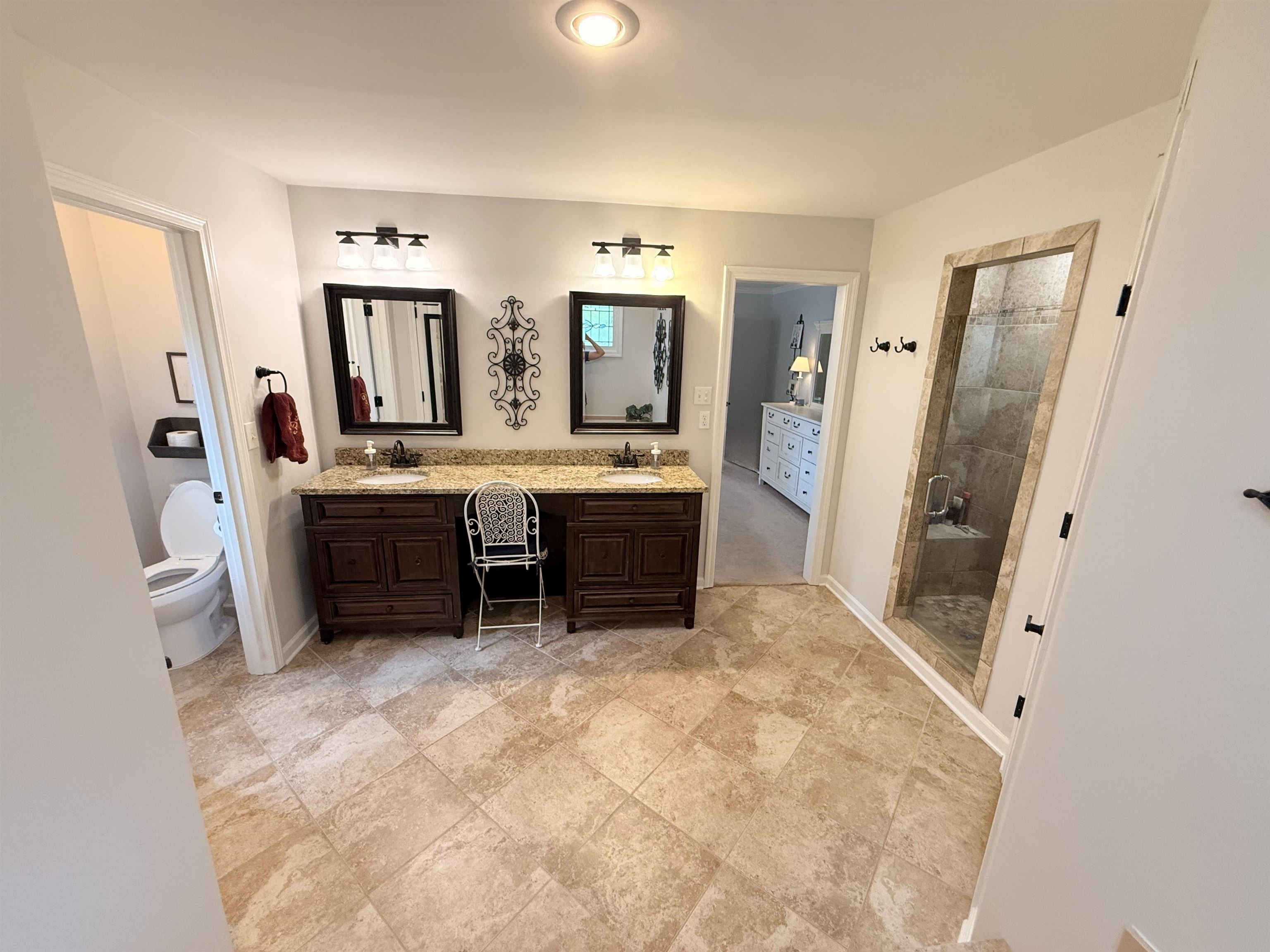 9140 Fox Ridge Road Germantown, TN 38139 - Photo 13 of 23 a large bathroom with a tub sink and mirror