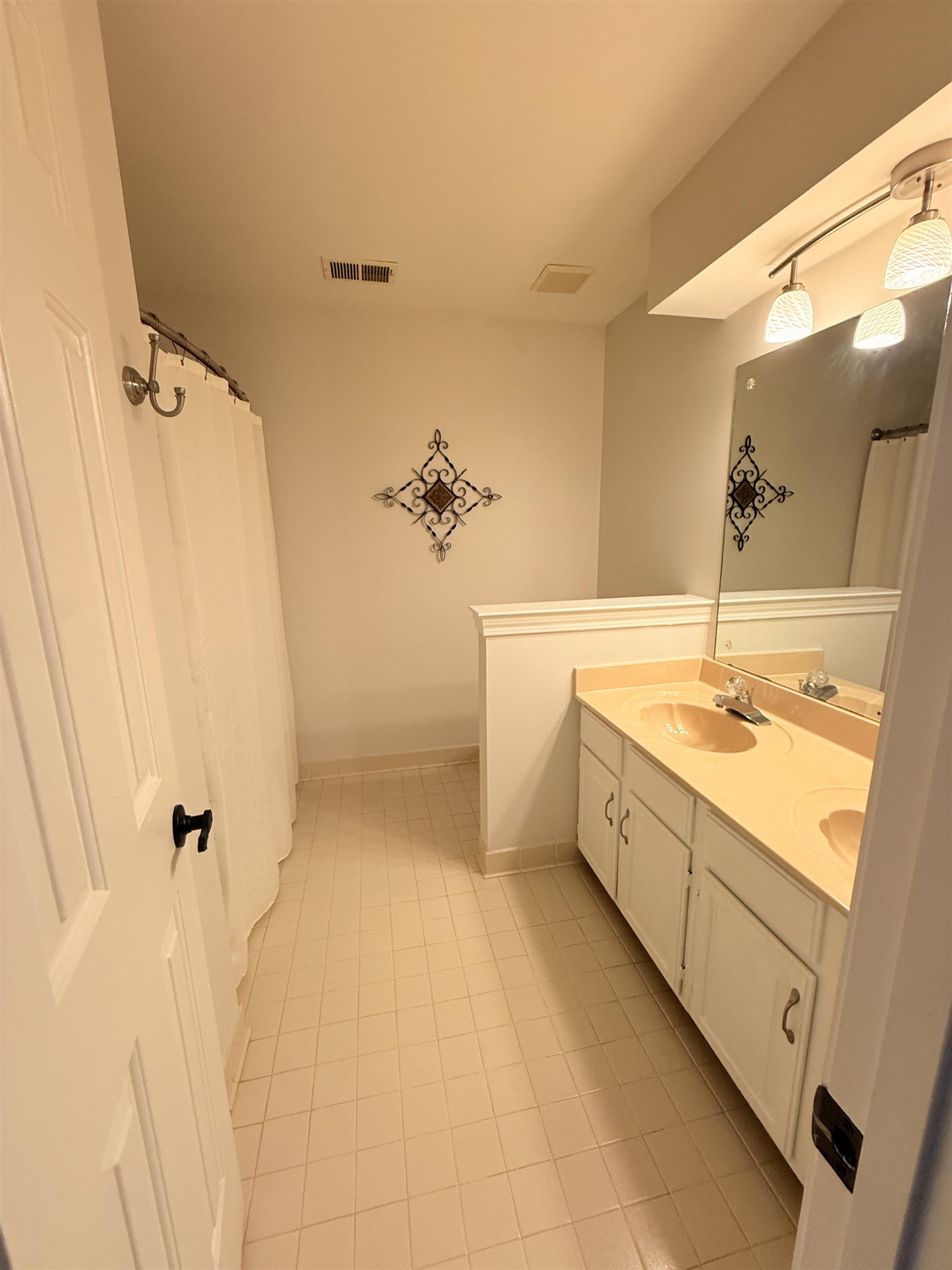 9140 Fox Ridge Road Germantown, TN 38139 - Photo 20 of 23 a bathroom with a double vanity sink a mirror and a bathtub