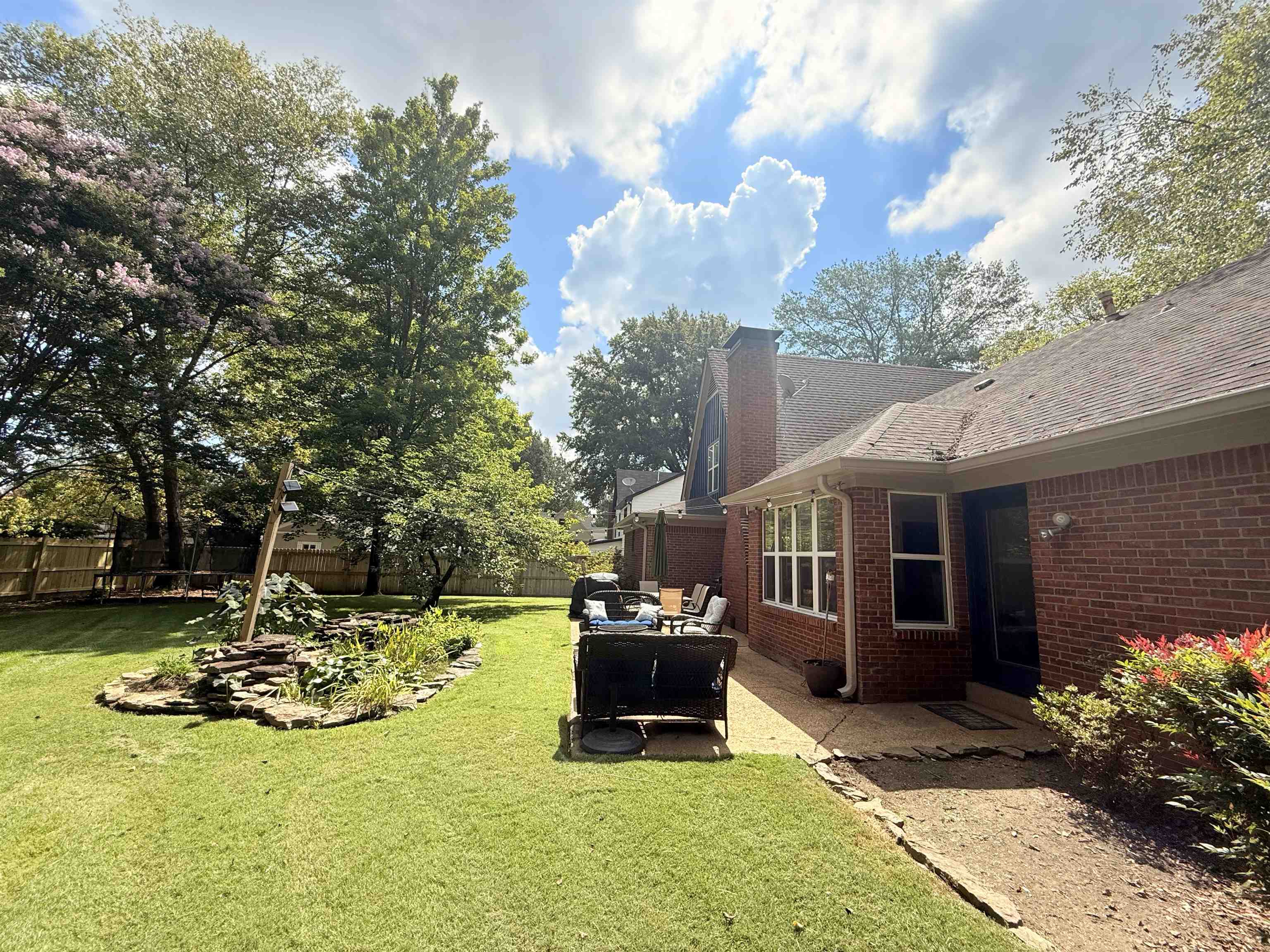 9140 Fox Ridge Road Germantown, TN 38139 - Photo 22 of 23 a view of a patio with table and chairs a barbeque with wooden fence