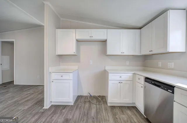 a kitchen with white cabinets and white appliances