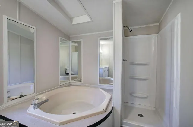 a bathroom with a sink a bathtub and a shower