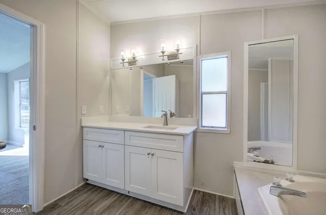 a bathroom with a double vanity sink and a mirror