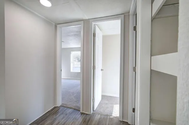 a view of a hallway with wooden floor
