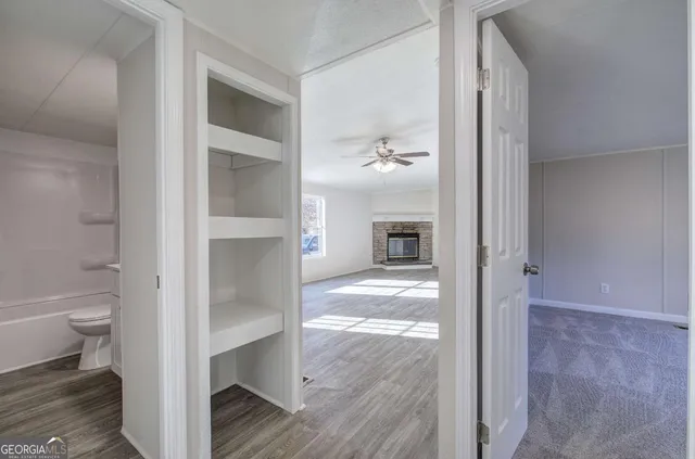 a view of bathroom from a hallway with toilet