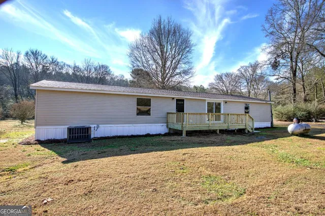 a view of a house with a yard covered in snow
