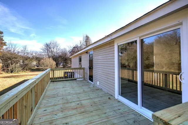 a view of a balcony with wooden floor and fence