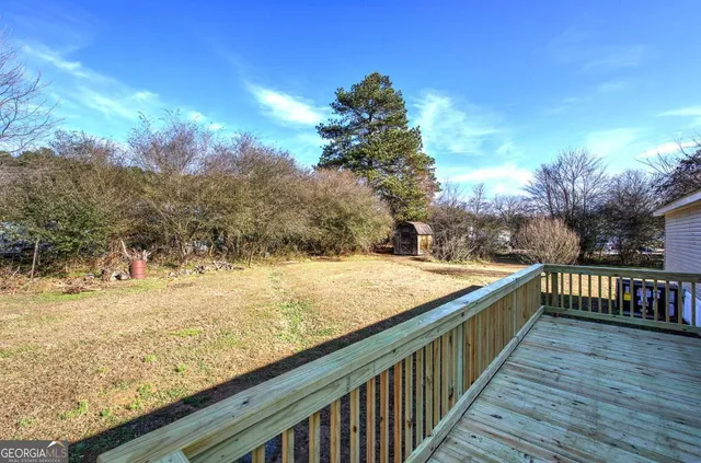 a view of a backyard with wooden fence