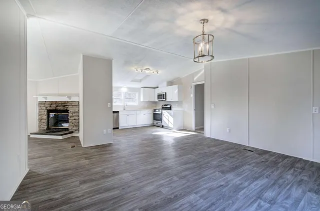 a view of a kitchen with wooden floor and a sink