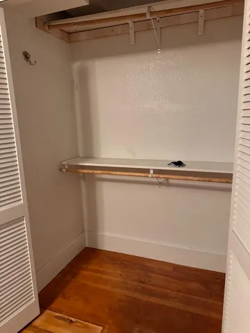 a view of a room with wooden floor