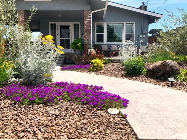 a front view of a house with a yard and fountain