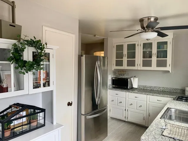 a kitchen with stainless steel appliances granite countertop a refrigerator and a stove