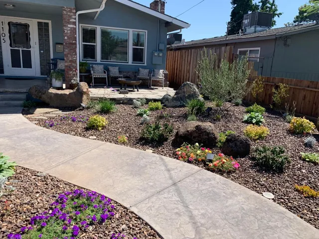 a view of a house with sitting area and garden