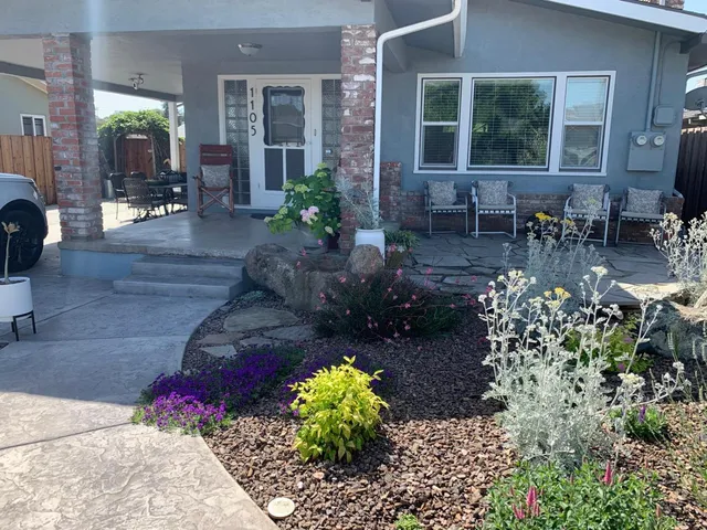 a view of a patio with table and chairs and potted plants
