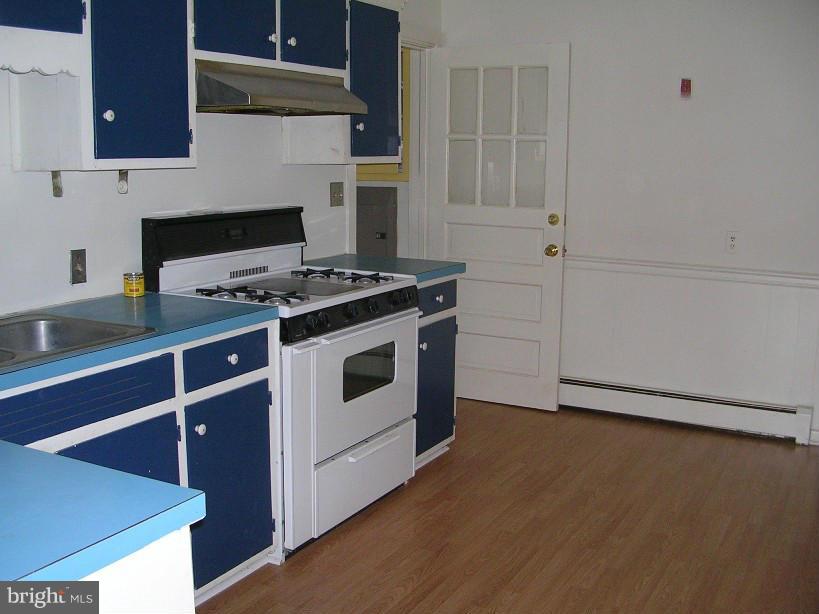 608 Wye Mills Road Queenstown, MD 21658 - Photo 7 of 17 a white stove top oven sitting inside of a kitchen