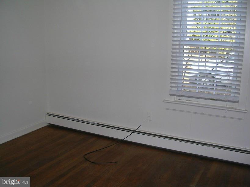 608 Wye Mills Road Queenstown, MD 21658 - Photo 9 of 17 a view of a small space with wooden floor and a window