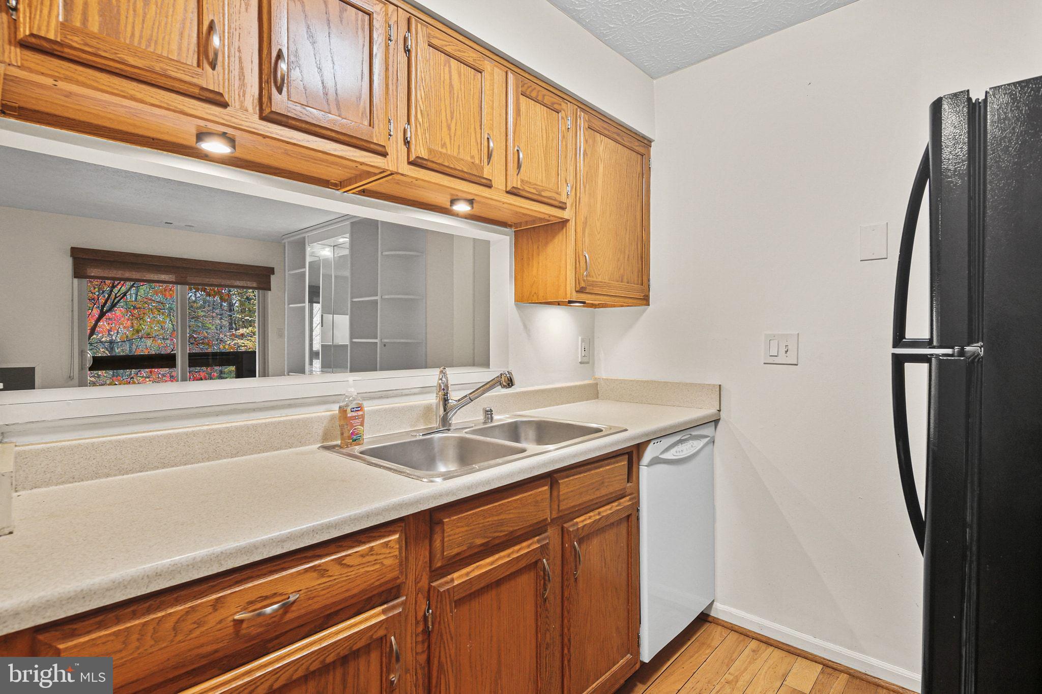 11450 Little Patuxent Parkway, Unit 605 Columbia, MD 21044 - Photo 11 of 33 a kitchen with a sink and a refrigerator