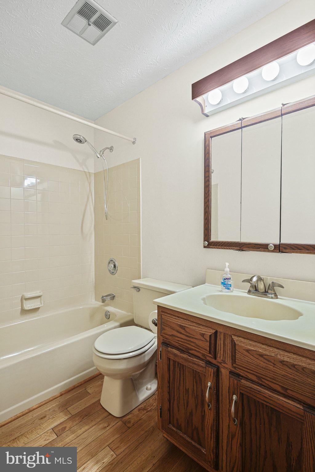 11450 Little Patuxent Parkway, Unit 605 Columbia, MD 21044 - Photo 16 of 33 a bathroom with a sink a toilet and a large mirror