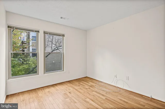 a view of a room with wooden floor