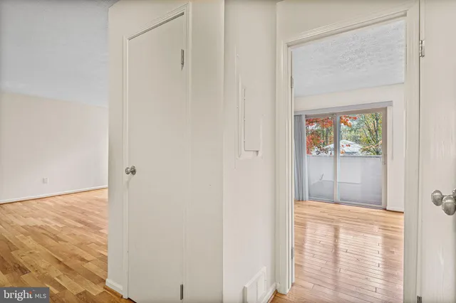 a view of a hallway with wooden floor