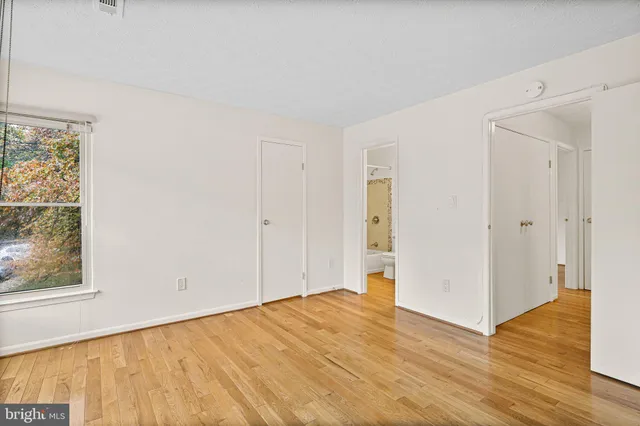 a view of empty room with wooden floor