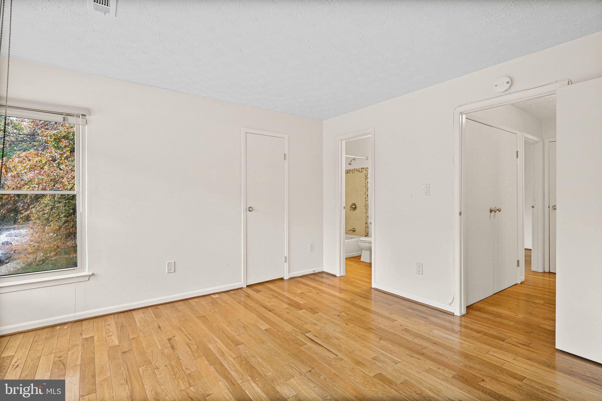 11450 Little Patuxent Parkway, Unit 605 Columbia, MD 21044 - Photo 24 of 33 a view of empty room with wooden floor and fan