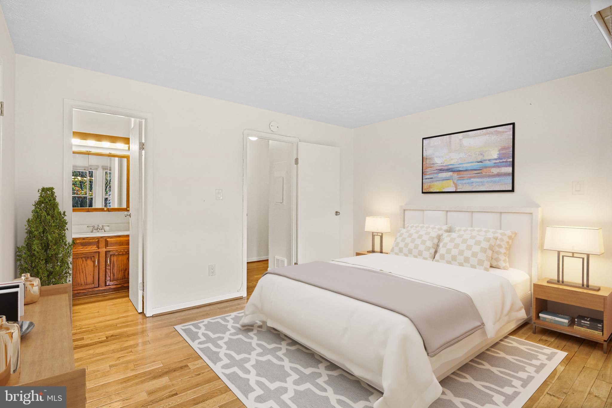 11450 Little Patuxent Parkway, Unit 605 Columbia, MD 21044 - Photo 25 of 33 a bedroom with a bed and wooden floor