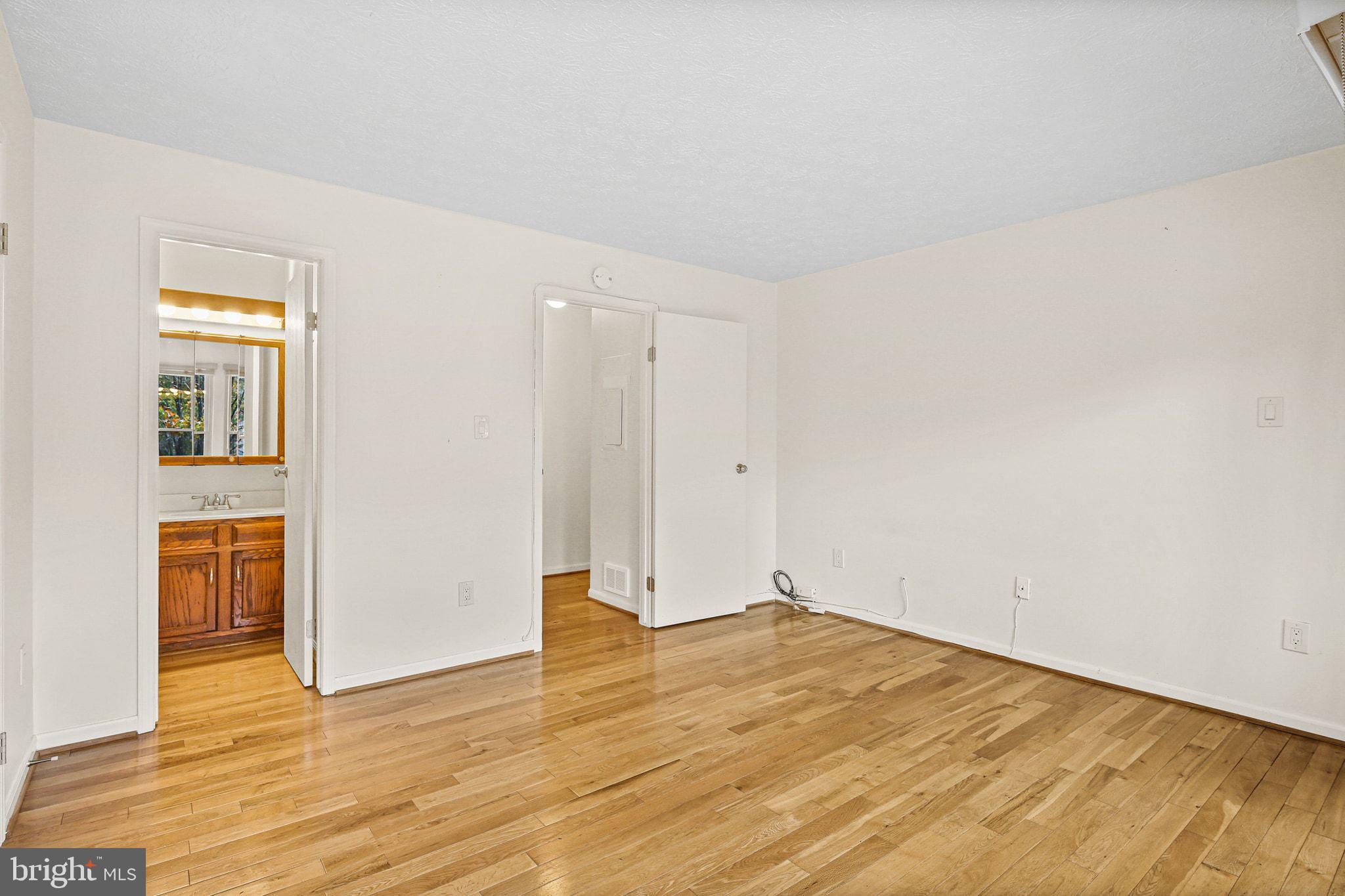 11450 Little Patuxent Parkway, Unit 605 Columbia, MD 21044 - Photo 26 of 33 a view of empty room with wooden floor