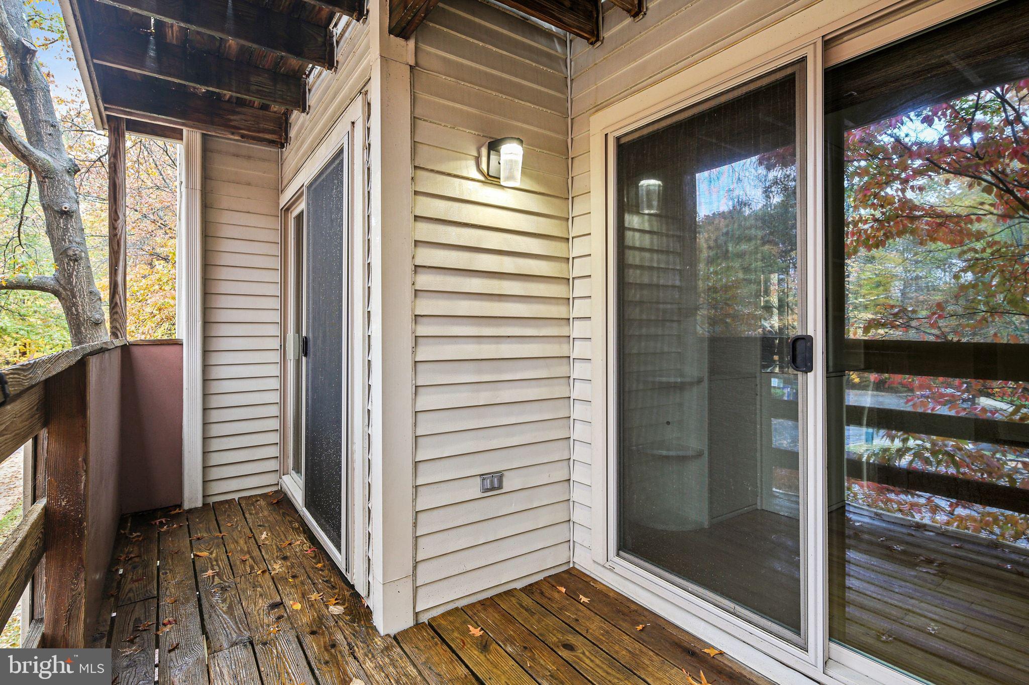 11450 Little Patuxent Parkway, Unit 605 Columbia, MD 21044 - Photo 32 of 33 a view of a balcony with wooden floor and iron stairs