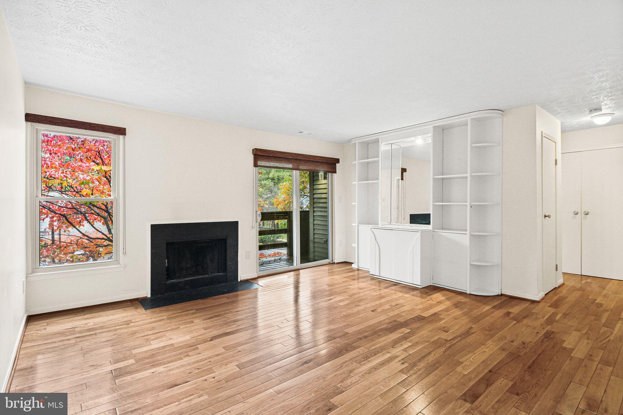 11450 Little Patuxent Parkway, Unit 605 Columbia, MD 21044 - Photo 7 of 33 a view of empty room with wooden floor and fireplace