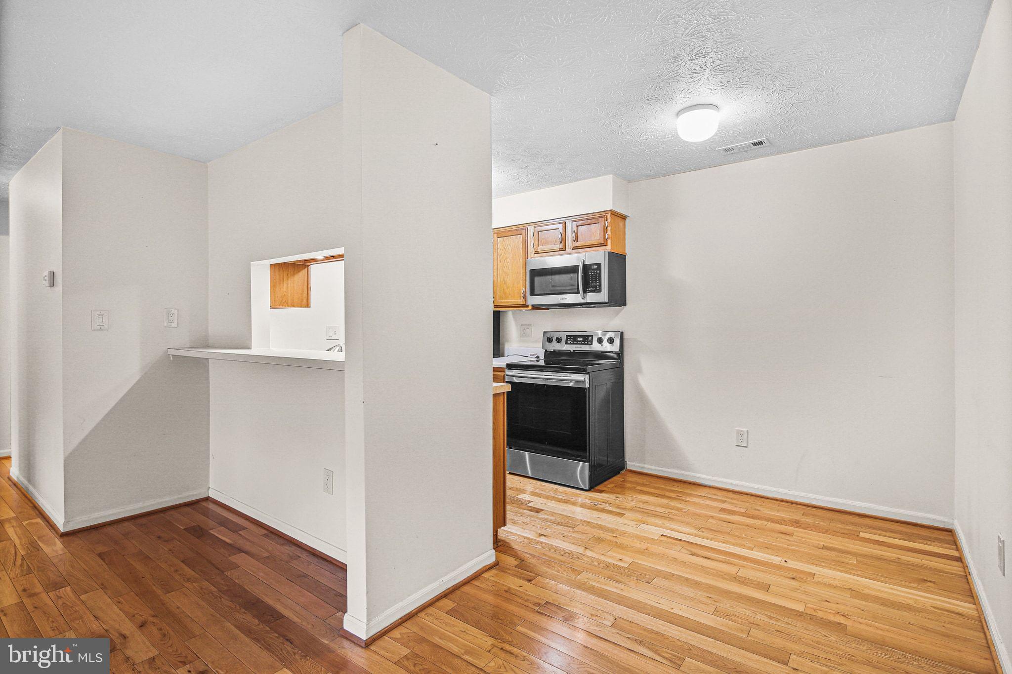 11450 Little Patuxent Parkway, Unit 605 Columbia, MD 21044 - Photo 8 of 33 a view of kitchen and wooden floor