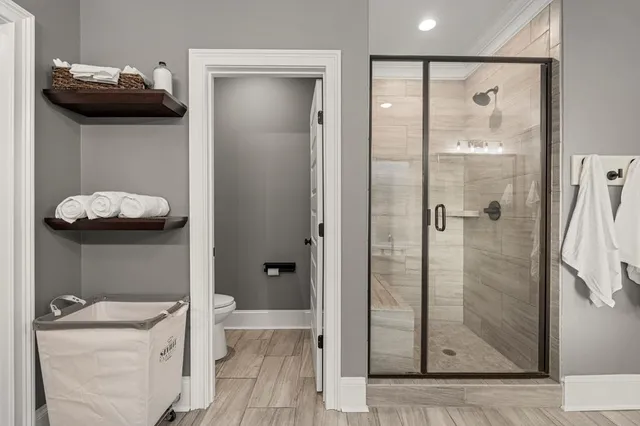 a bathroom with a granite countertop sink a mirror and shower