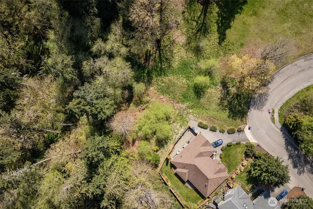 a view of a yard with wooden fence