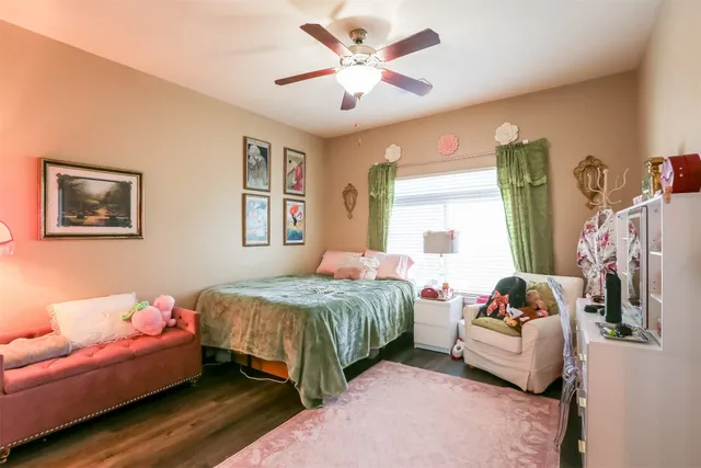 a bedroom with a bed and windows