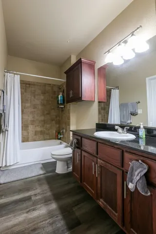 a bathroom with a sink a large mirror and a bathtub
