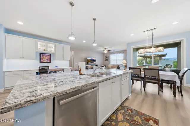 a kitchen with center island table and chairs