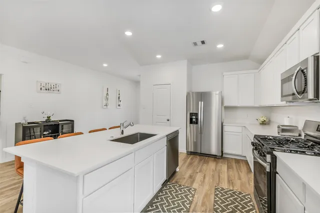 a kitchen that has a sink and a stove in it