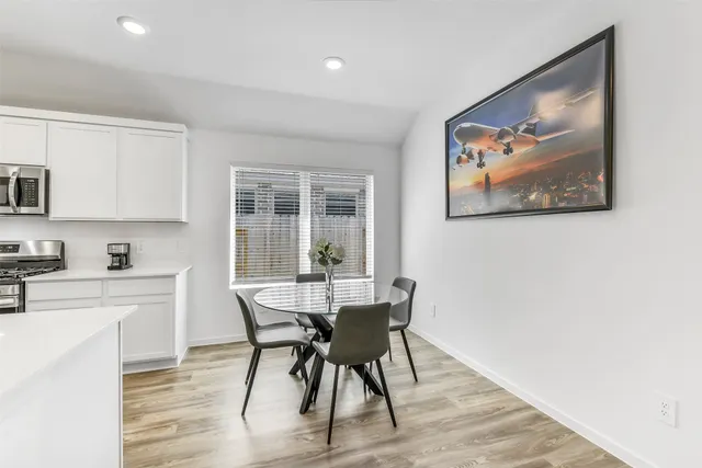 a view of a dining room with furniture and wooden floor