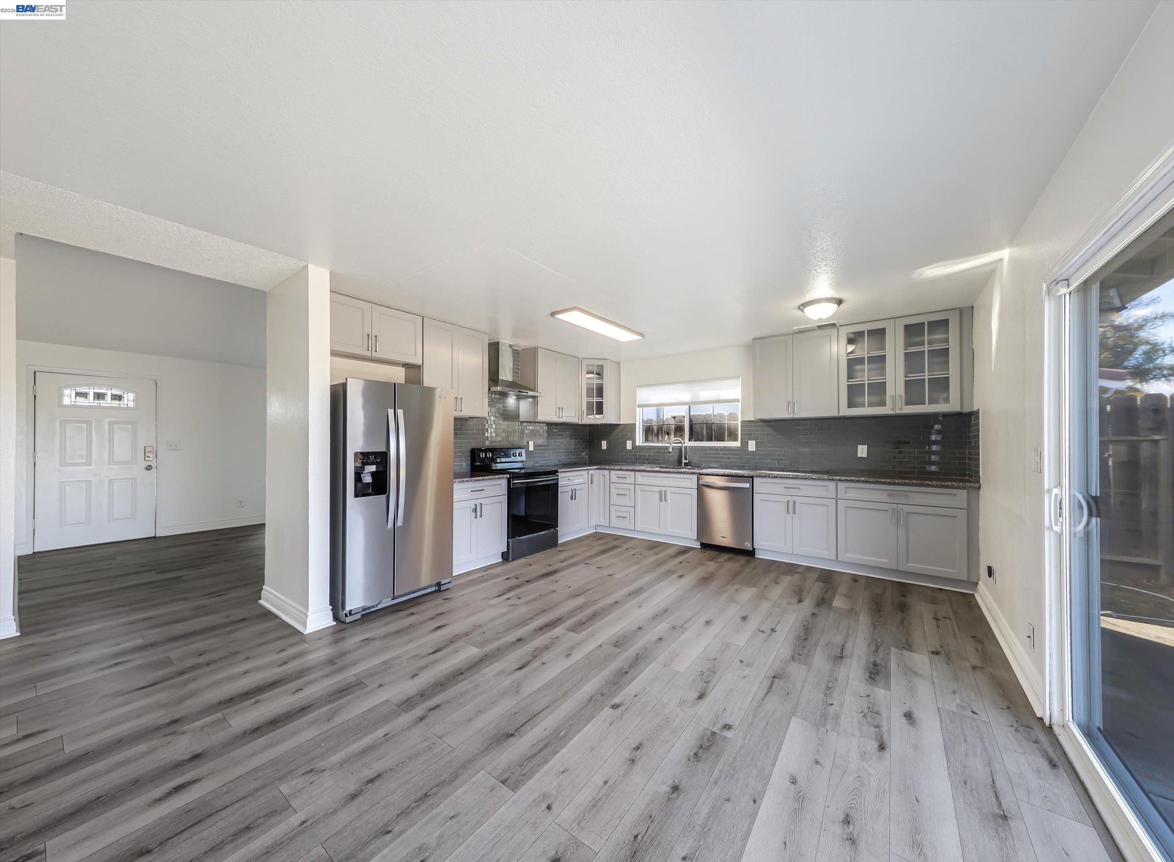 3432 Danielle Place Bay Point, CA 94565 - Photo 10 of 36 a large kitchen with a center island wooden floor stainless steel appliances and cabinets