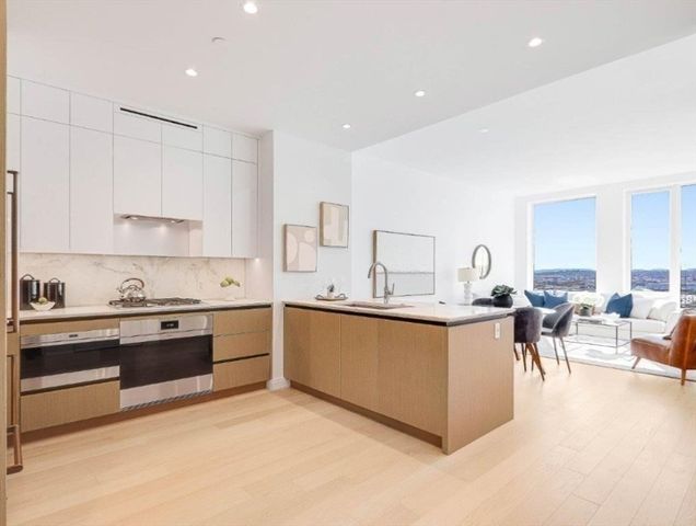 a kitchen with stainless steel appliances granite countertop a stove and cabinets