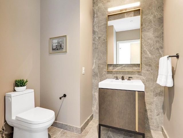 a bathroom with a sink toilet and mirror