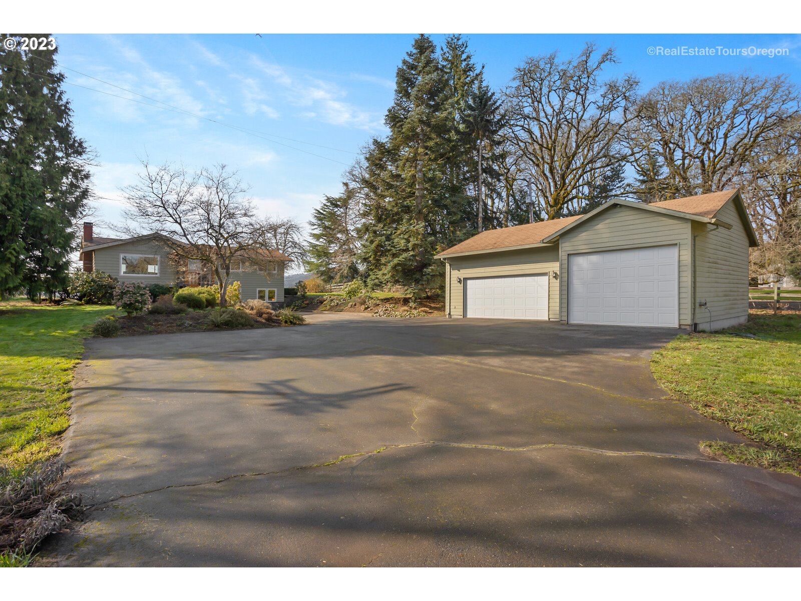 17224 Northwest Lucy Reeder Road Portland, OR 97231 - Photo 3 of 27 a view of a yard with a house and a large tree