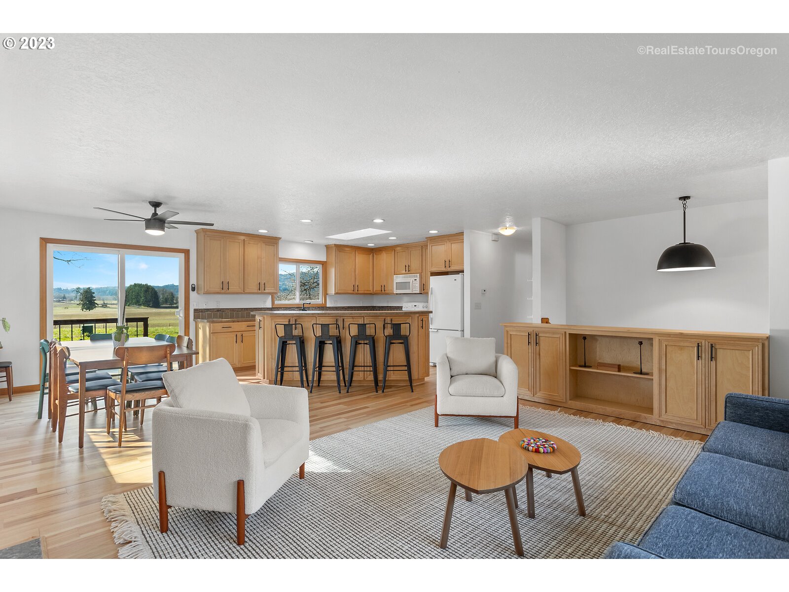 17224 Northwest Lucy Reeder Road Portland, OR 97231 - Photo 5 of 27 a living room with furniture and a wooden floor