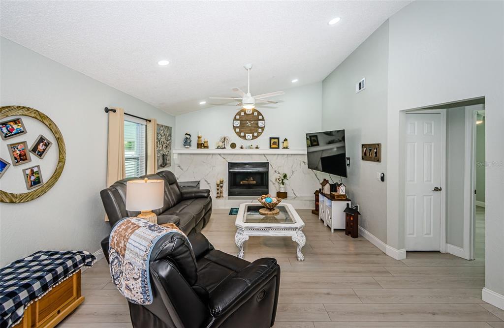 7547 Landmark Drive Spring Hill, FL 34606 - Photo 15 of 34 a living room with furniture fireplace and window
