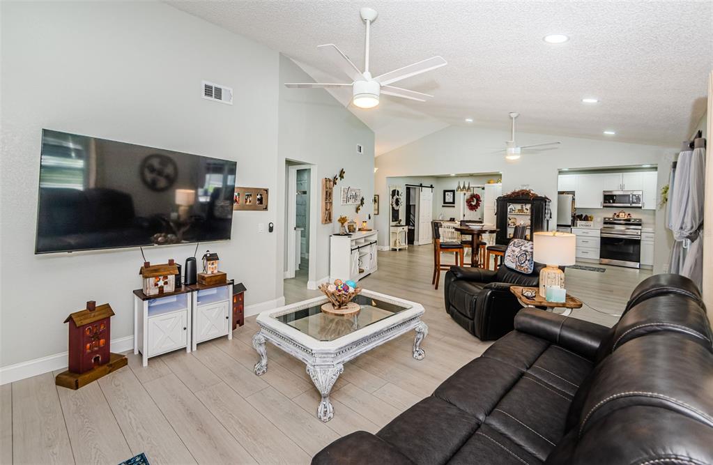 7547 Landmark Drive Spring Hill, FL 34606 - Photo 19 of 34 a living room with furniture and a flat screen tv