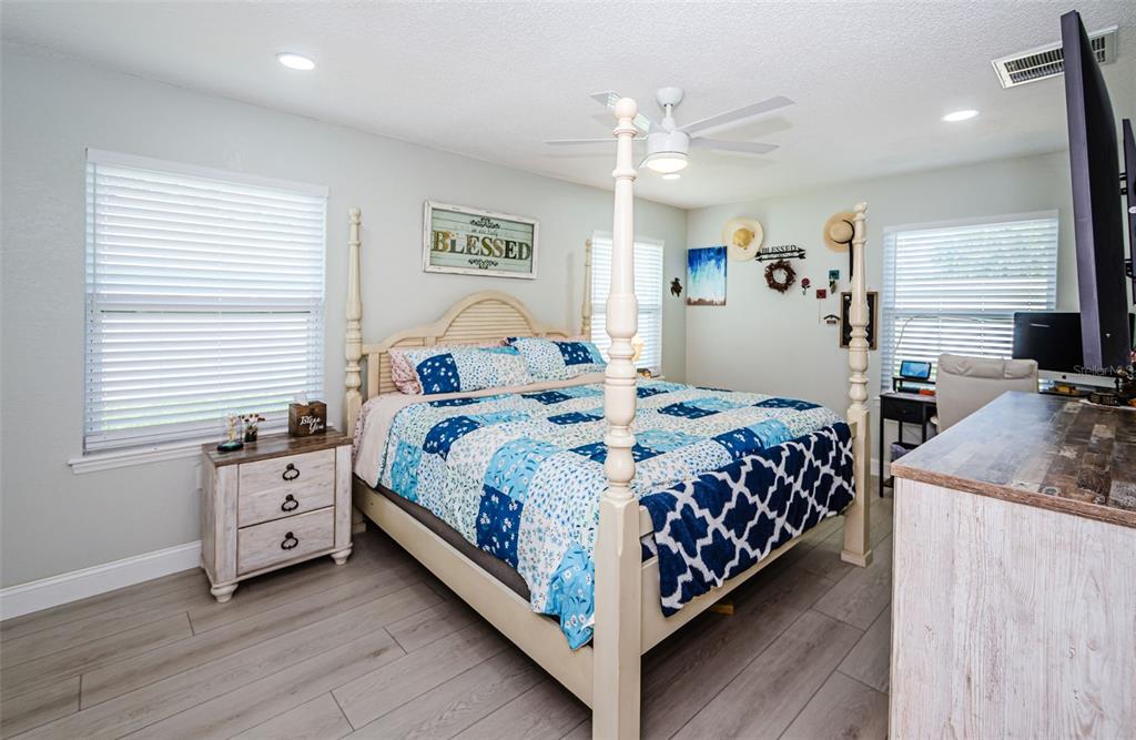 7547 Landmark Drive Spring Hill, FL 34606 - Photo 25 of 34 a bedroom with a bed and a chandelier