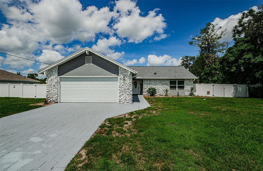 7547 Landmark Drive Spring Hill, FL 34606 - Photo 34 of 34 a front view of a house with a yard and garage